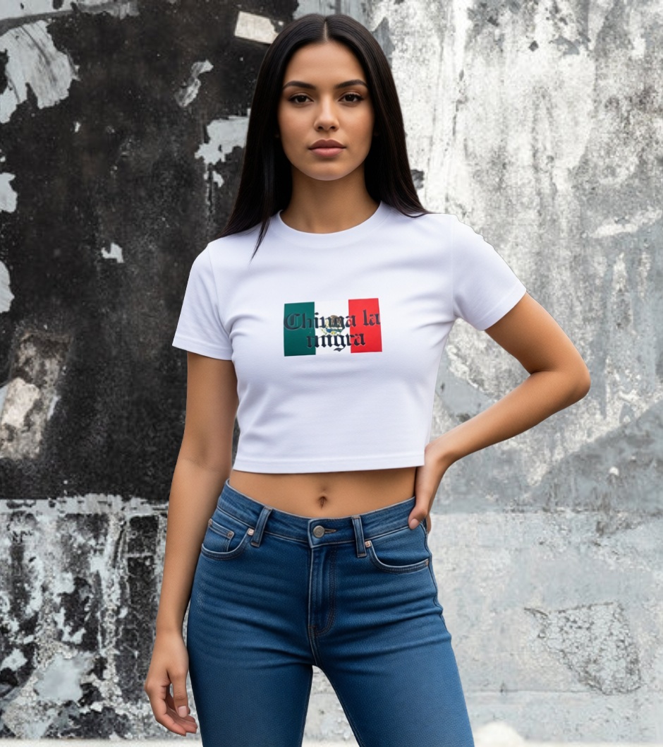 Woman wearing a white t-shirt with a Mexican flag against a textured wall.