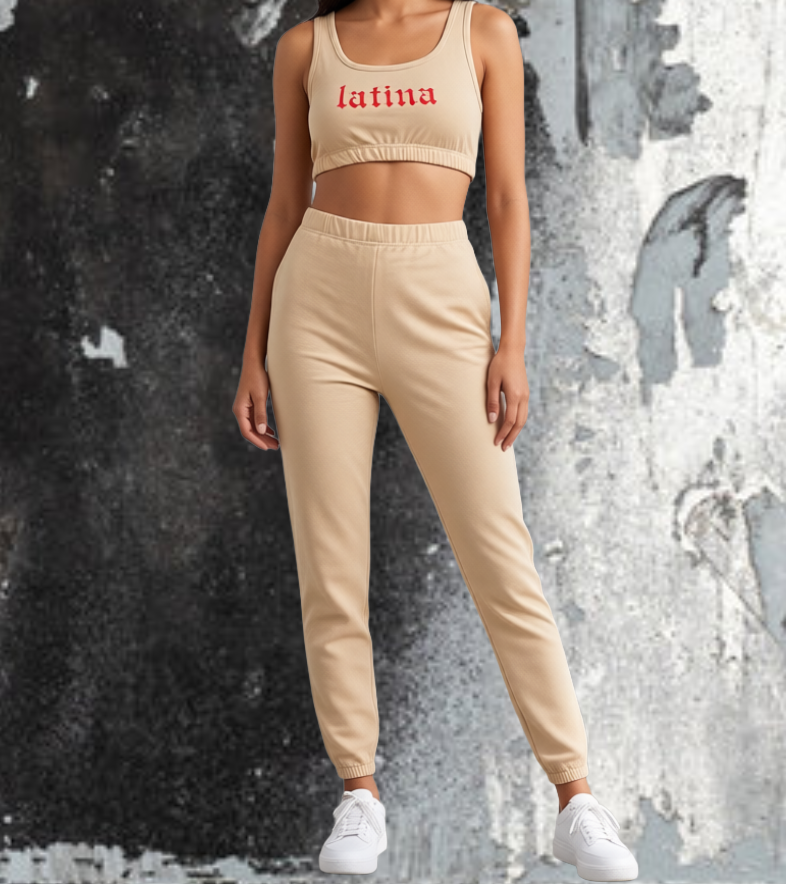Woman wearing a beige 'latina' sports bra and pants against a textured wall.
